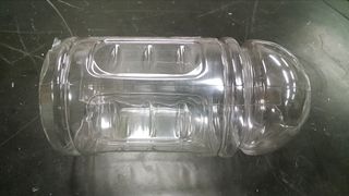 The top and bottom of the bottle are removed, and one cut has been made along the length.