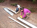Fig. 4e: Gabby and Bri prepping gutters for wiring