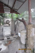 Fig 1d: Here is sand being put in the mixer. This photo displays the need for masks while working with blocks.