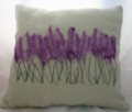 Do some embroidery on the cushion to create a pretty design
